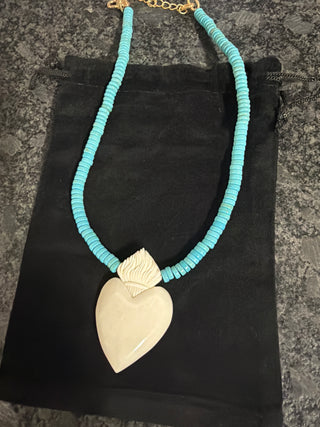 Handcrafted bone heart pendant with turquoise bead