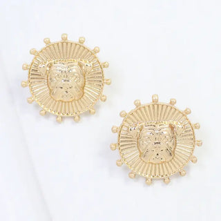 A pair of gold-toned stud earrings featuring a bulldog face surrounded by a sunburst pattern of small beads, displayed on a clean white background.